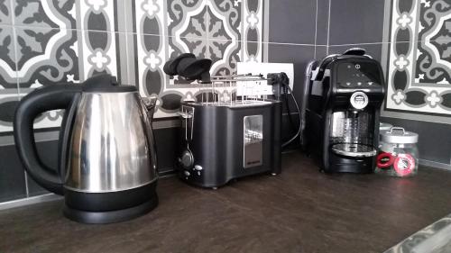 a kitchen counter with a coffee maker and a toaster at - Home Sweet Langhe - Room 51 in Alba