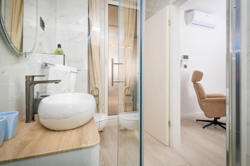 a bathroom with a white toilet and a sink at Apartman Palma and Luxury Penthouse for a family with swiming pool,parking,terrace,panoramic view at the sea,Podstrana in Podstrana