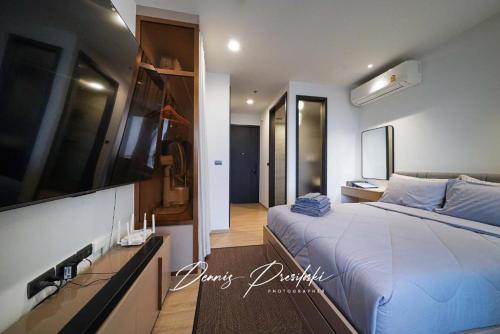 a bedroom with a large bed and a television at Luxury Edge Seaview Apartment in Pattaya South