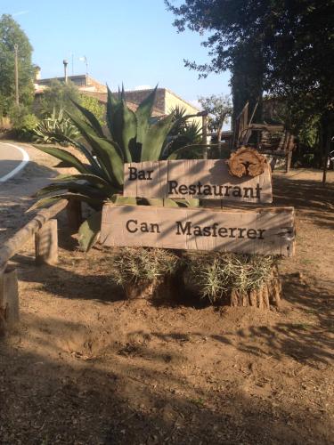 a sign that saysbin restaurant can masterger on a street at Can Masferrer in Riudarenes