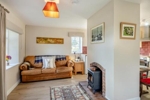 a living room with a couch and a fireplace at 2 Bed in Bressingham oc-f33646 in Bressingham