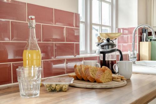 a kitchen counter with bread and a bottle of orange juice at 2 Bed in Bressingham oc-f33646 in Bressingham