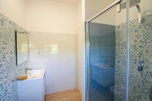 a bathroom with a glass shower and a sink at Villa Adele con piscina privata vicino Tropea - per 16 persone in Torre Marino