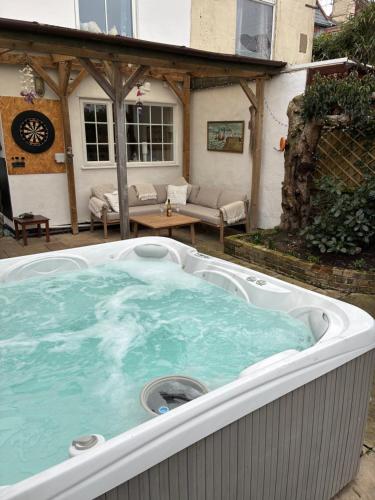 a hot tub in the backyard of a house at Large family home, sea view, hot tub, beach 5 min walk, dog friendly in Gorleston-on-Sea