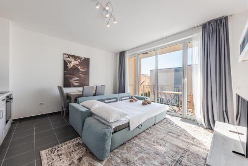 a bedroom with a bed and a large window at Serene Haven Talea by PikHost in Tale