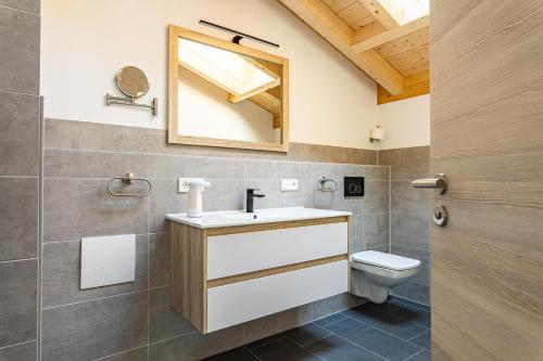 a bathroom with a sink and a toilet at Beim Huber in Hopferau