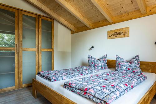 a bedroom with a bed and a window at Beim Huber in Hopferau