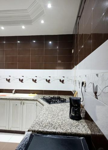 a kitchen with a stove and a counter top at modern apartment in Akouda