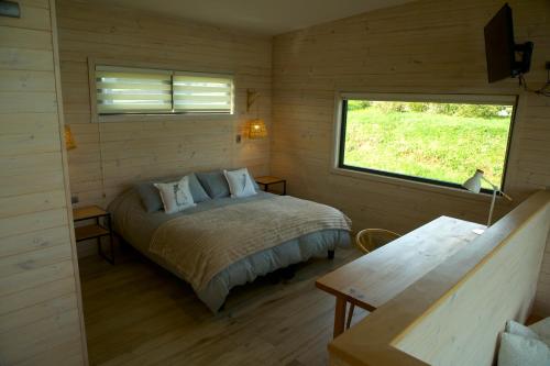 a bedroom with a bed in a room with a window at Parcela Nueve in Frutillar