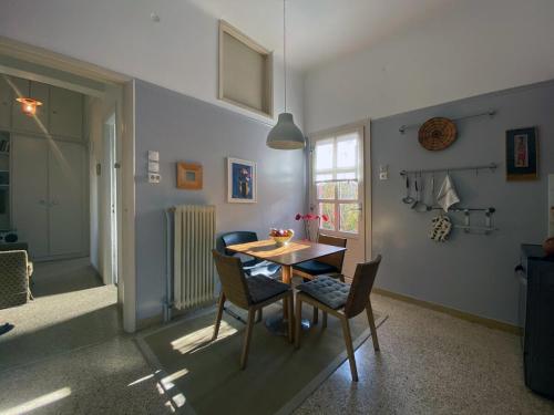 a dining room with a table and chairs in a room at Bamboo & Bird House, Chalandri in Athens