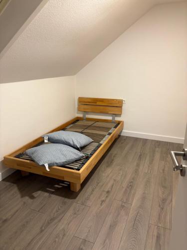 a bed with two pillows in a room at Red Dot Apartment Bruno in Werne an der Lippe