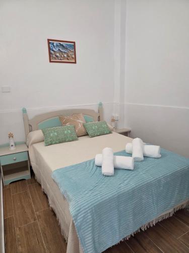 a bedroom with a bed with towels on it at La Perlita in Las Eras