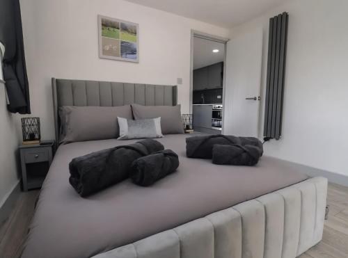 a large bed with three pillows on top of it at The Cabin - Private Car Park with CCTV - Fast WiFi - Peaceful Retreat with Views for Business or Couples in Oldbury