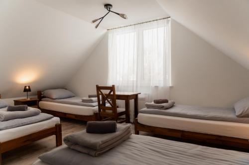 a room with four beds and a window at Mościce Dolne 69 in Nowosiółki