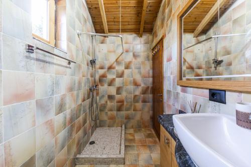 a bathroom with a shower and a sink and a tub at Ferma Gold by PikHost in Tirana
