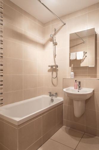 a bathroom with a bath tub and a sink at Best City Centre Luxurious Home Free Parking in Belfast