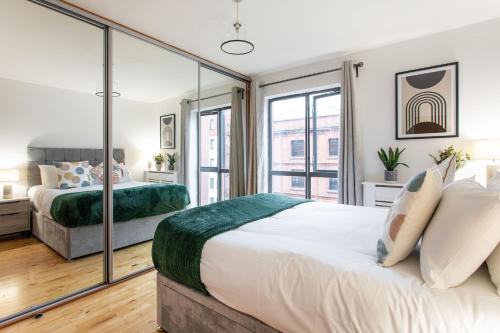 a bedroom with two beds and a large window at Best City Centre Luxurious Home Free Parking in Belfast