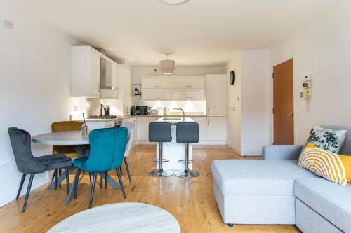 a living room with a couch and a table at Best City Centre Luxurious Home Free Parking in Belfast