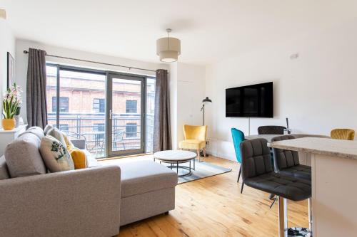 a living room with a couch and a table at Best City Centre Luxurious Home Free Parking in Belfast