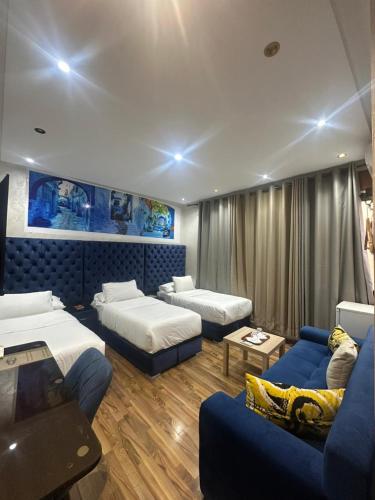 a living room with two beds and a couch at Hotel Annasr in Chefchaouen