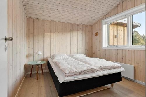 a bedroom with a bed in a room with a window at 0186-Romo-Egedesminde-3 in Høm