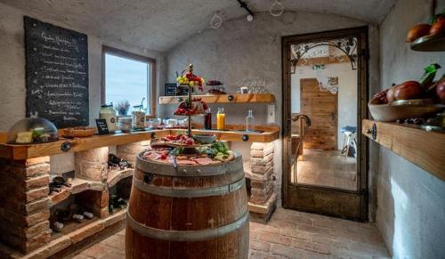 a kitchen with a counter and a barrel in a room at BuchackerAlm -1,5h panoramic walk in Angerberg