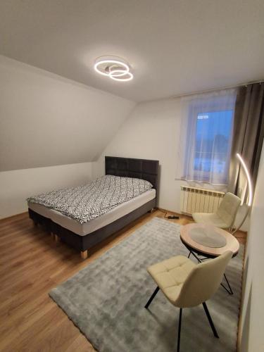 a bedroom with a bed and a table and chairs at House in Zabierzów in Zabierzów