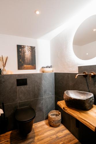 a bathroom with a sink on a wooden counter at Hotel Gasthof Koch in Daaden