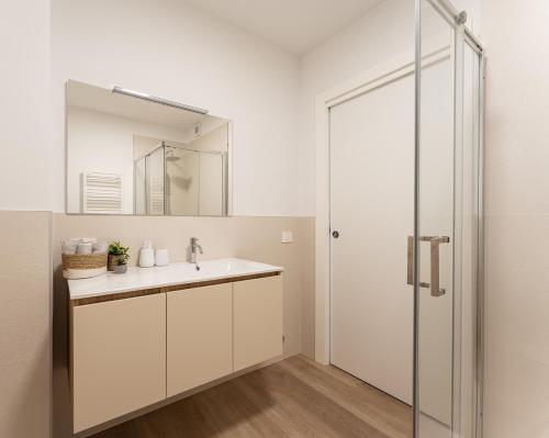 a bathroom with a sink and a mirror at Dama Apartments in San Vito di Leguzzano