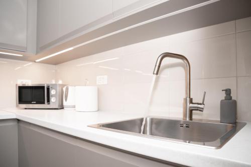 a kitchen counter with a sink and a microwave at Apartment Alen in Makarska