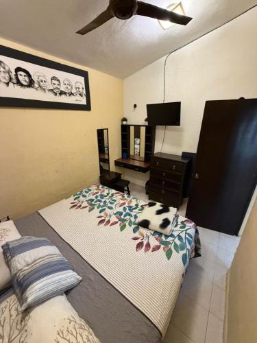 a bedroom with two beds and a dresser and a fan at Casa KIRICHNA cerca de centro comercial Y AIRPORT in Chetumal
