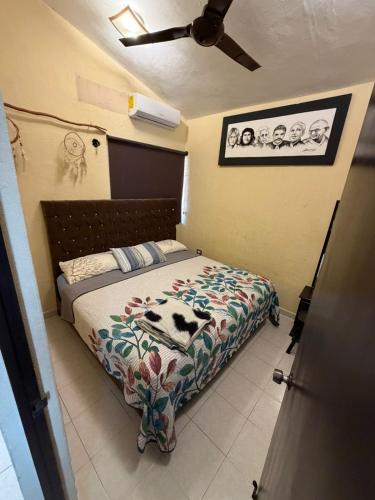 a bedroom with a bed with a blanket on it at Casa KIRICHNA cerca de centro comercial Y AIRPORT in Chetumal