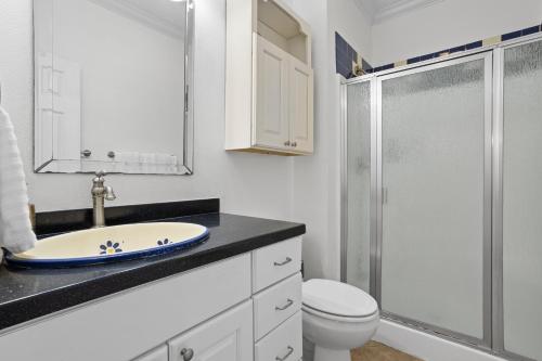 a bathroom with a sink and a toilet and a shower at Steps from the Sand and Town Green - 2BR Coastal Retreat in Long Beach