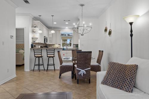 a living room with a couch and a table and chairs at Steps from the Sand and Town Green - 2BR Coastal Retreat in Long Beach