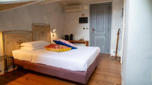 a bedroom with a bed with a basket on it at Locanda Al Cappello in Udine