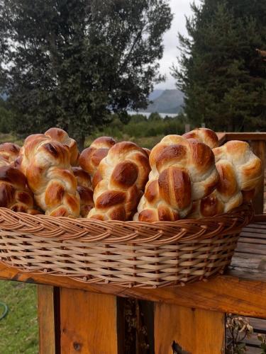 a basket of bread sitting on a wooden table at Hostería Meliquina in Lago Meliquina