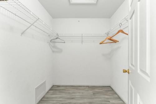 a hallway with white walls and an open door at Branson 2BR Retreat | Jacuzzi + Gym + Pools in Hollister