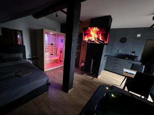 a bedroom with a bed and a fireplace with a tv at Wellness & Spa Zaprešić in Jablanovec
