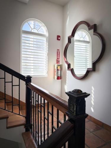 a staircase with two windows and a mirror at Acacia Boutique Hotel in San Juan
