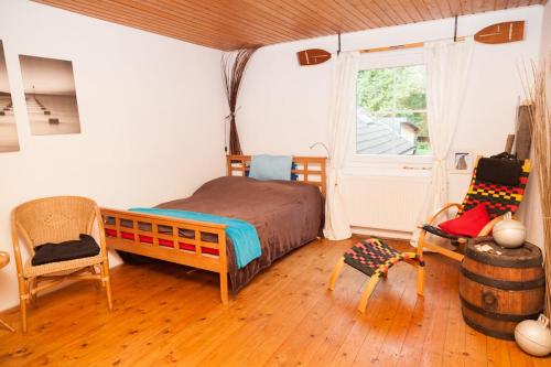 a bedroom with a bed and a chair and a window at Canoe Welcome in Hattingen