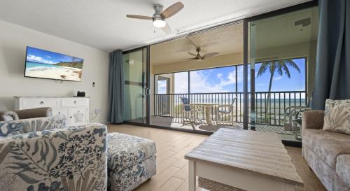 a living room with a view of the ocean at Mariner's Boathouse and Beach Resort by CoolVacay in Fort Myers Beach