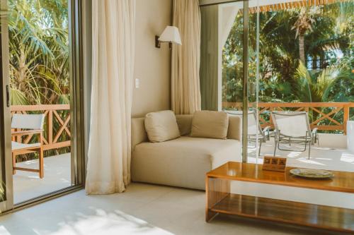 a living room with a couch and a table at Secret Garden Hideaway in Balcheil