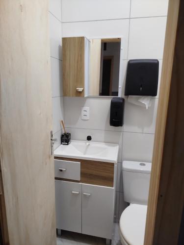 a small bathroom with a sink and a toilet at Republica Fusinato in Itajaí