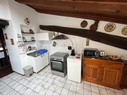 a small kitchen with a stove and a sink at Ca’ Adele in Morbegno