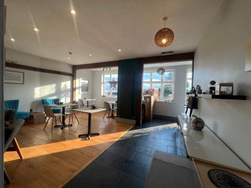 a living room with a table and chairs at Riverside Cottage B&B in Lynmouth
