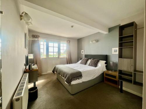 a bedroom with a bed and a window at Riverside Cottage B&B in Lynmouth