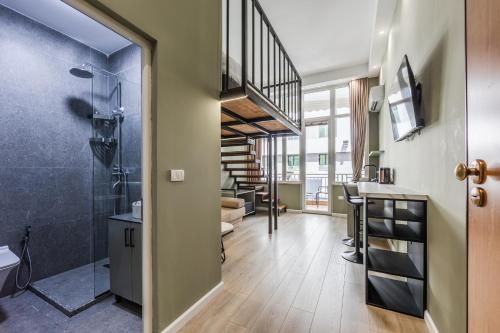a bathroom with a walk in shower and a sink at Amel's Rooms by PikHost in Tirana