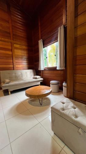 a living room with a couch and a coffee table at Casa Guarapari in Guarapari