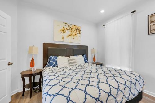 a bedroom with a bed with a blue and white comforter at Detroit 3BR in Mexicantown | Sleeps 7 + WiFi in Detroit