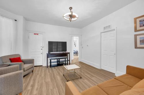 a living room with a couch and a television at Detroit 3BR in Mexicantown | Sleeps 7 + WiFi in Detroit